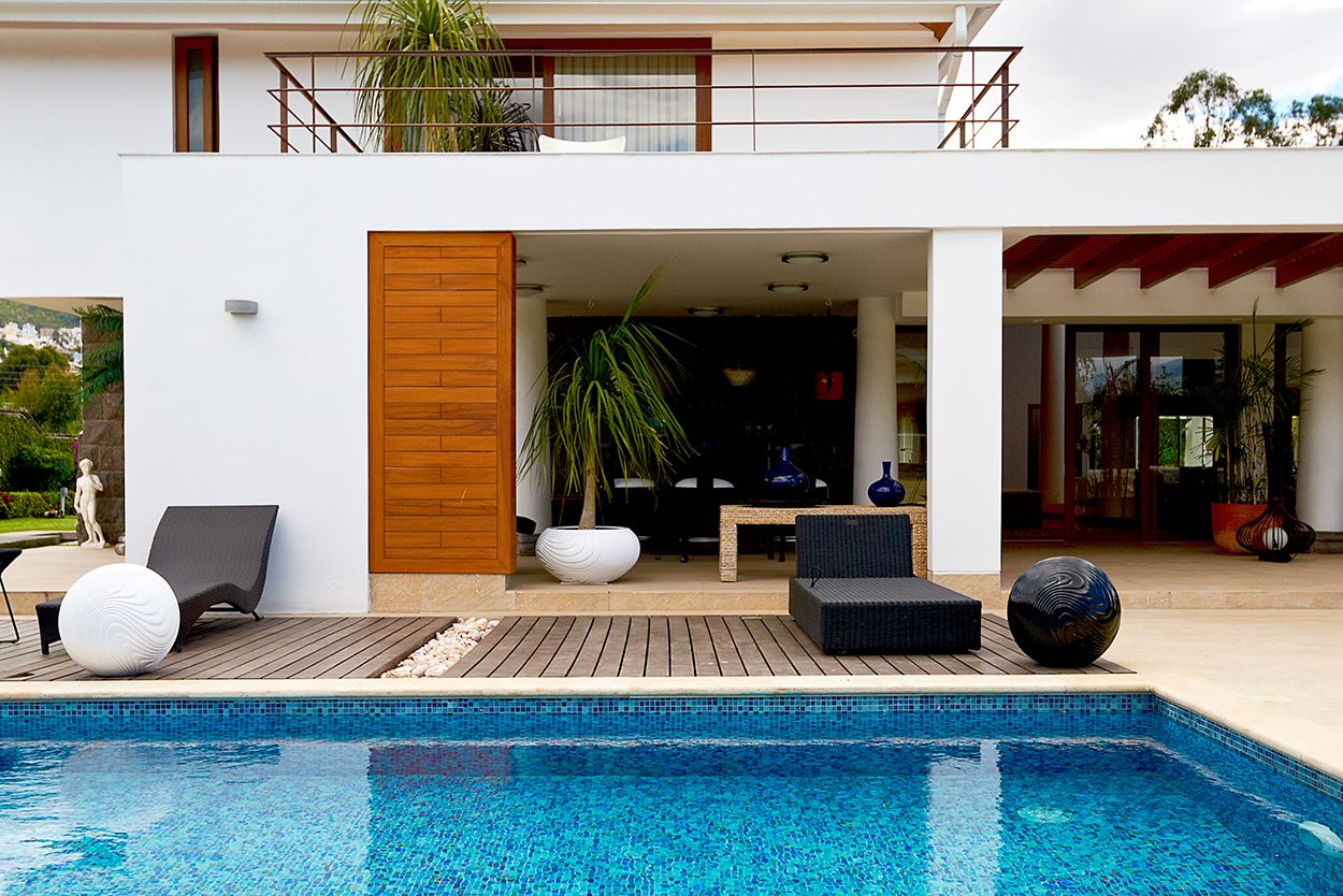 outdoor deck with chairs and pool